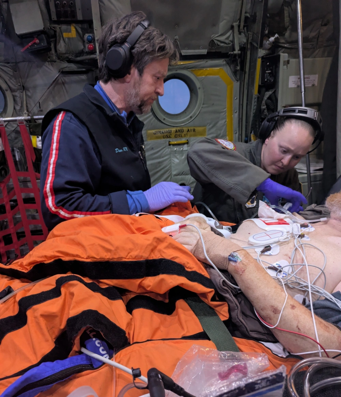 Two medics working with a patient