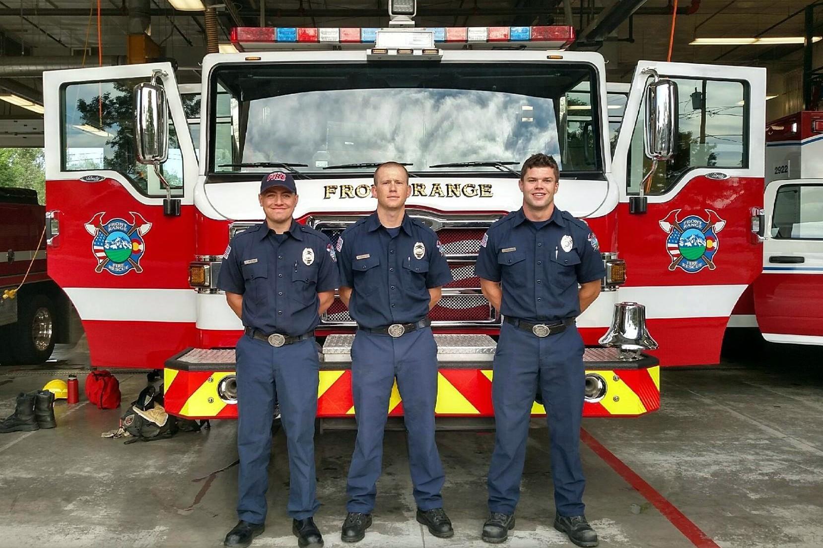 Firefighter Wright, Firefighter Geisick, and Firefighter Stephenson Standing in Front of Firetruck